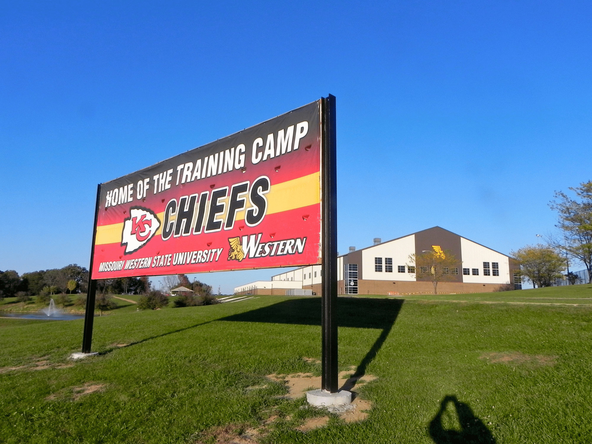 Sign in front of building that says Home of the Training Camp for the Kansas City Chiefs