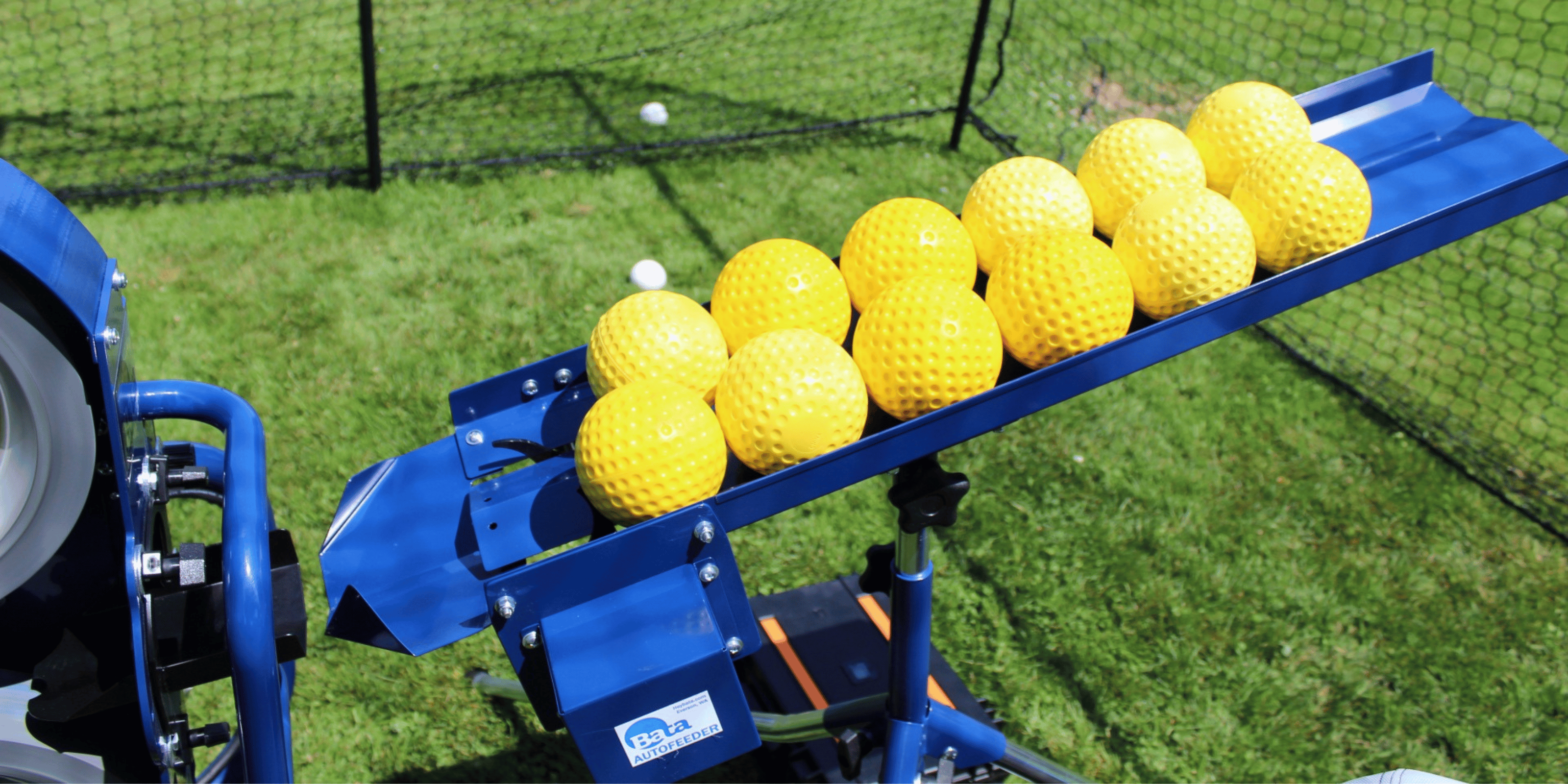 Yellow softballs loaded into auto feeder 