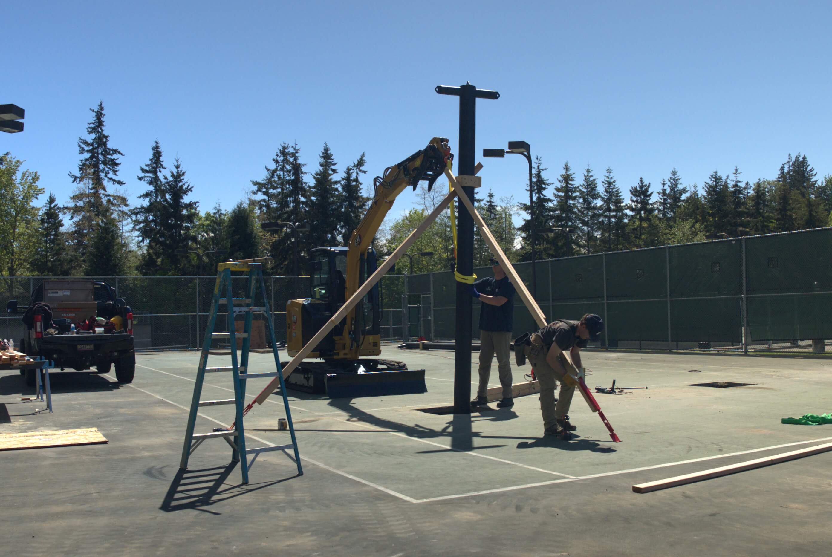 Mastodon batting cage poles being put into the footings at western washington university