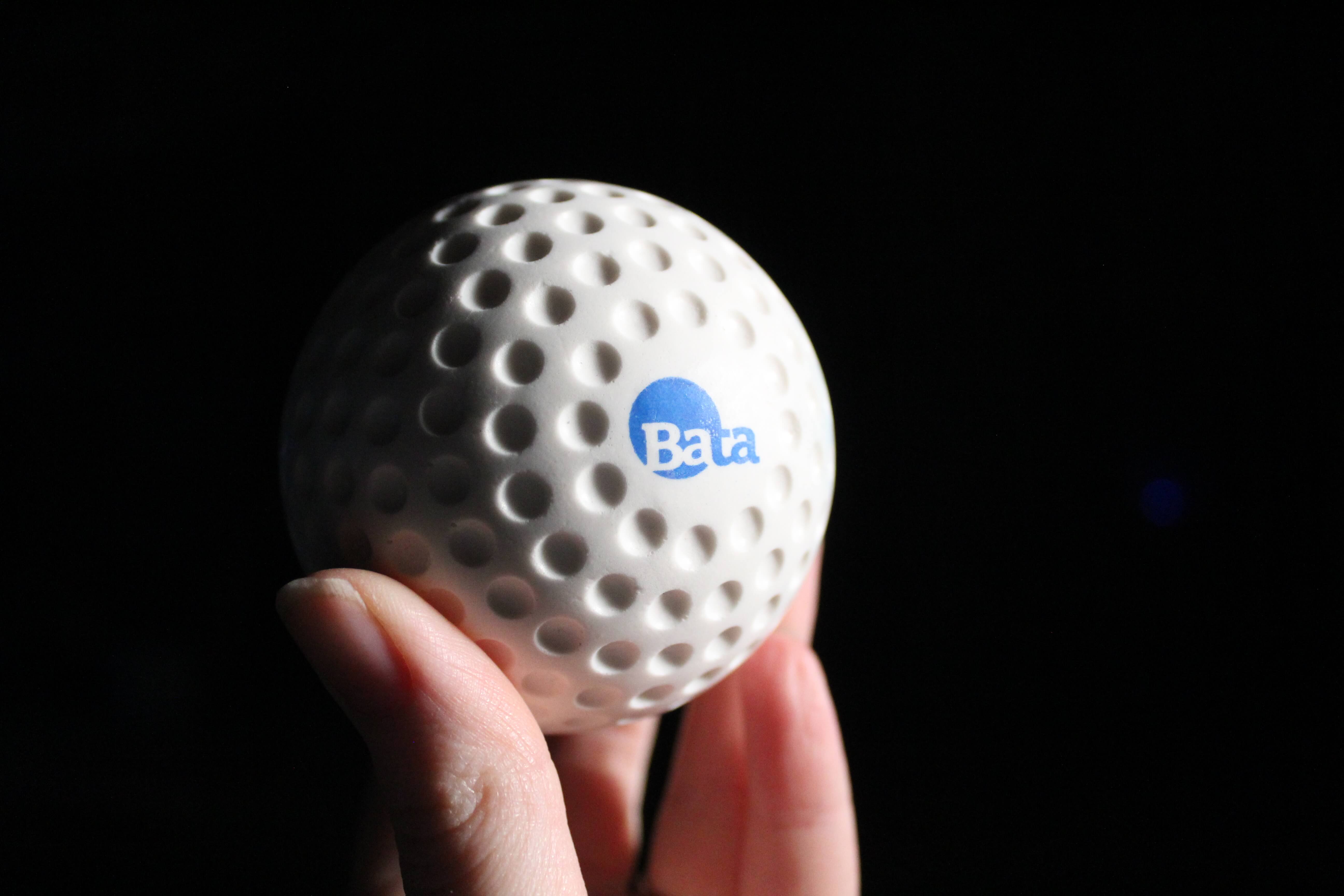 Lightweight bata dimpled baseballs in persons hand