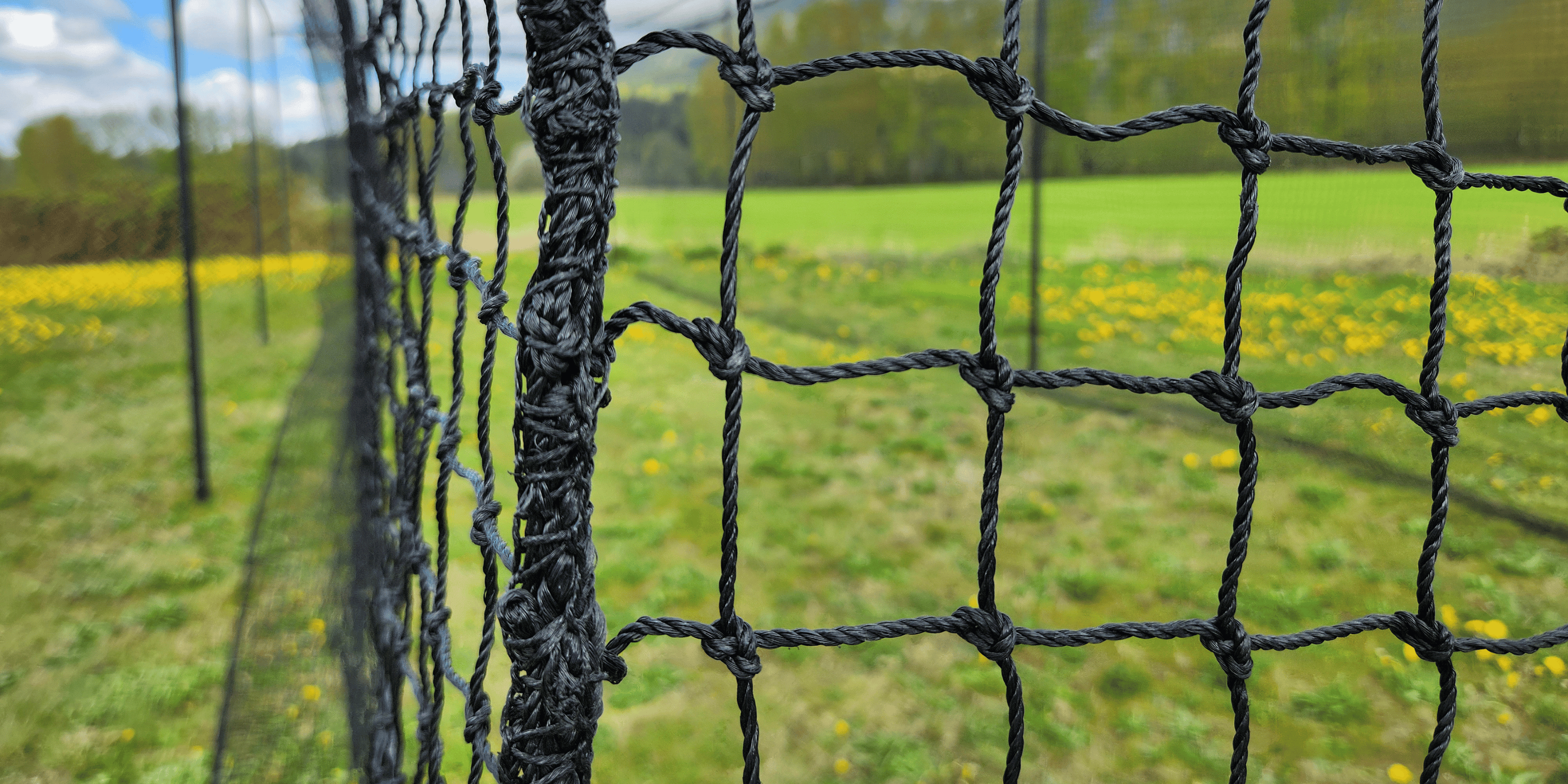 Close up view of batting cage net rope border and netting meshes