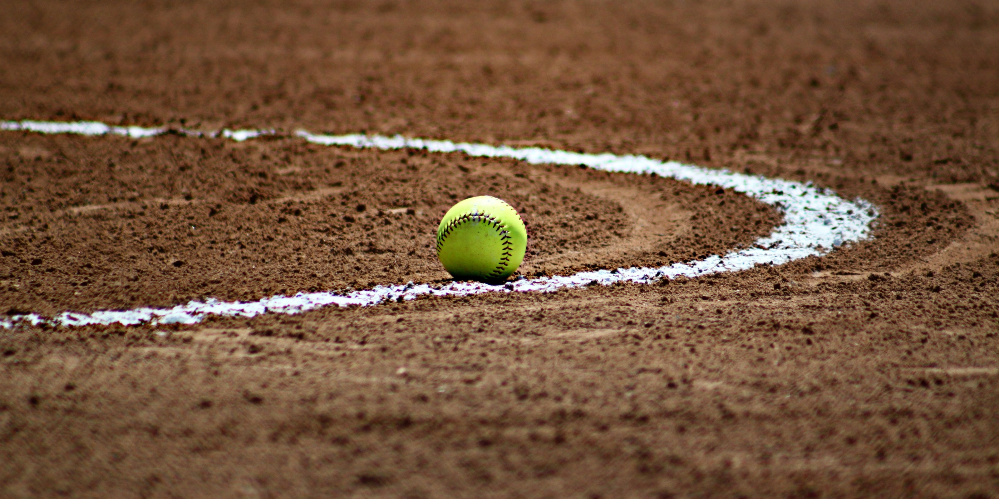 Softball Field line with yellow softball 