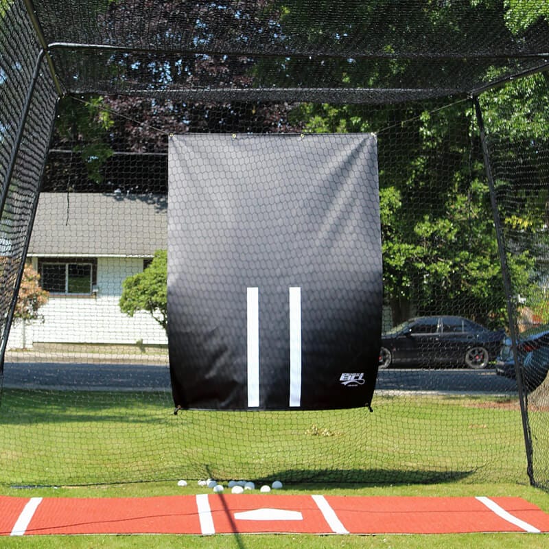 5ft x 7ft Vinyl Backdrop hung inside the Trapezoid cage with the batters mat underneath