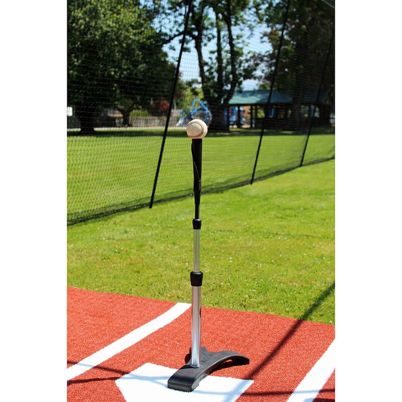 Tanner Heavy Batting Tee on batters box mat in a batting cage