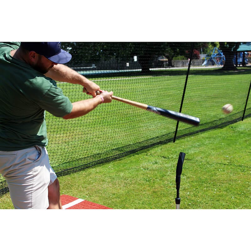 Man hitting a baseball off of the Tanner Heavy Batting Tee