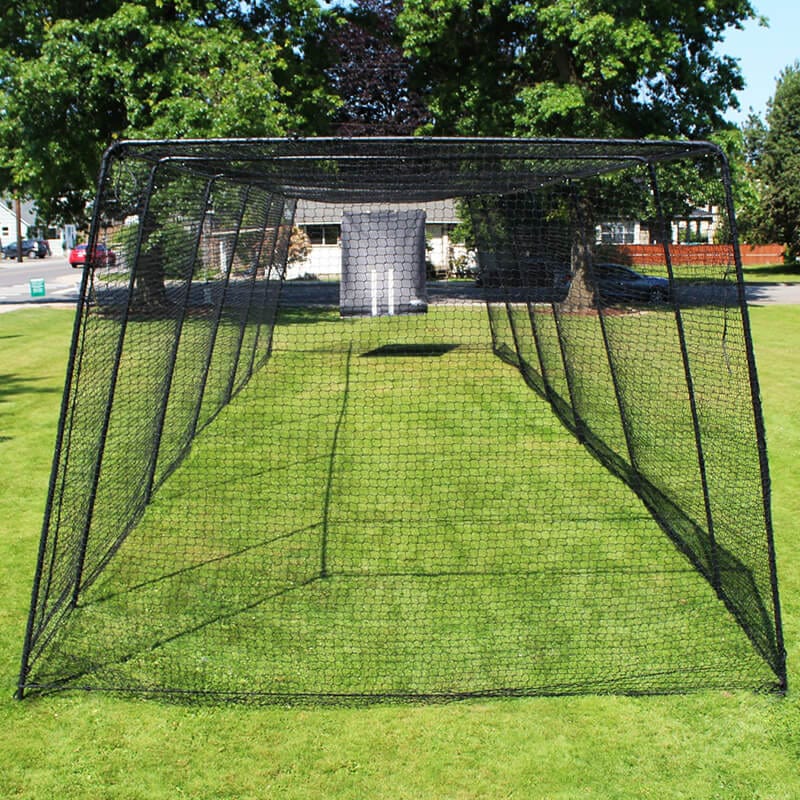 Freestanding Trapezoid Batting Cage in a park with green grass and trees