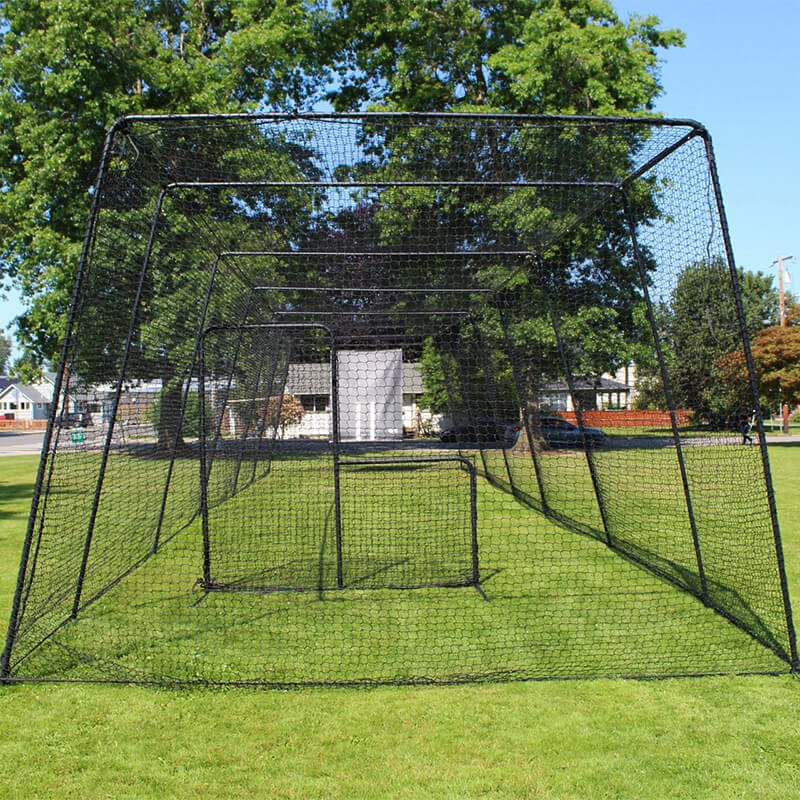 Freestanding Trapezoid Batting Cage in a park with green grass and trees