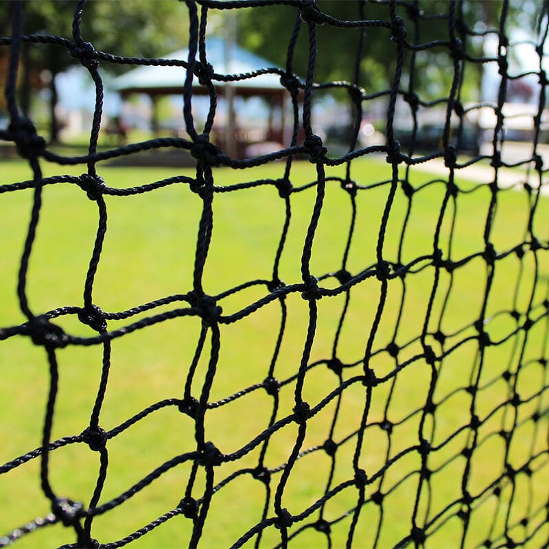 Standard Baseball Protective L-Screen netting close up with green grass behind