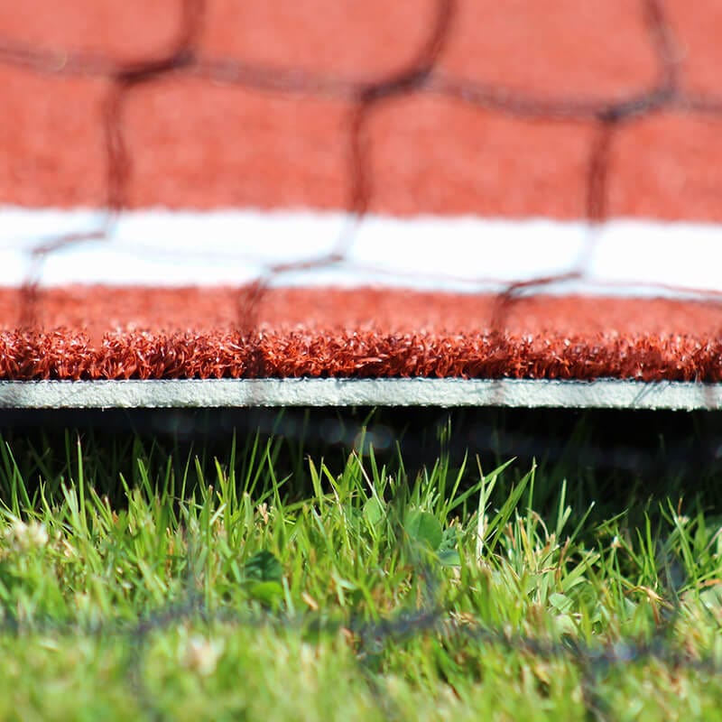 Edge of clay Deluxe Batter's Box Mat on grass