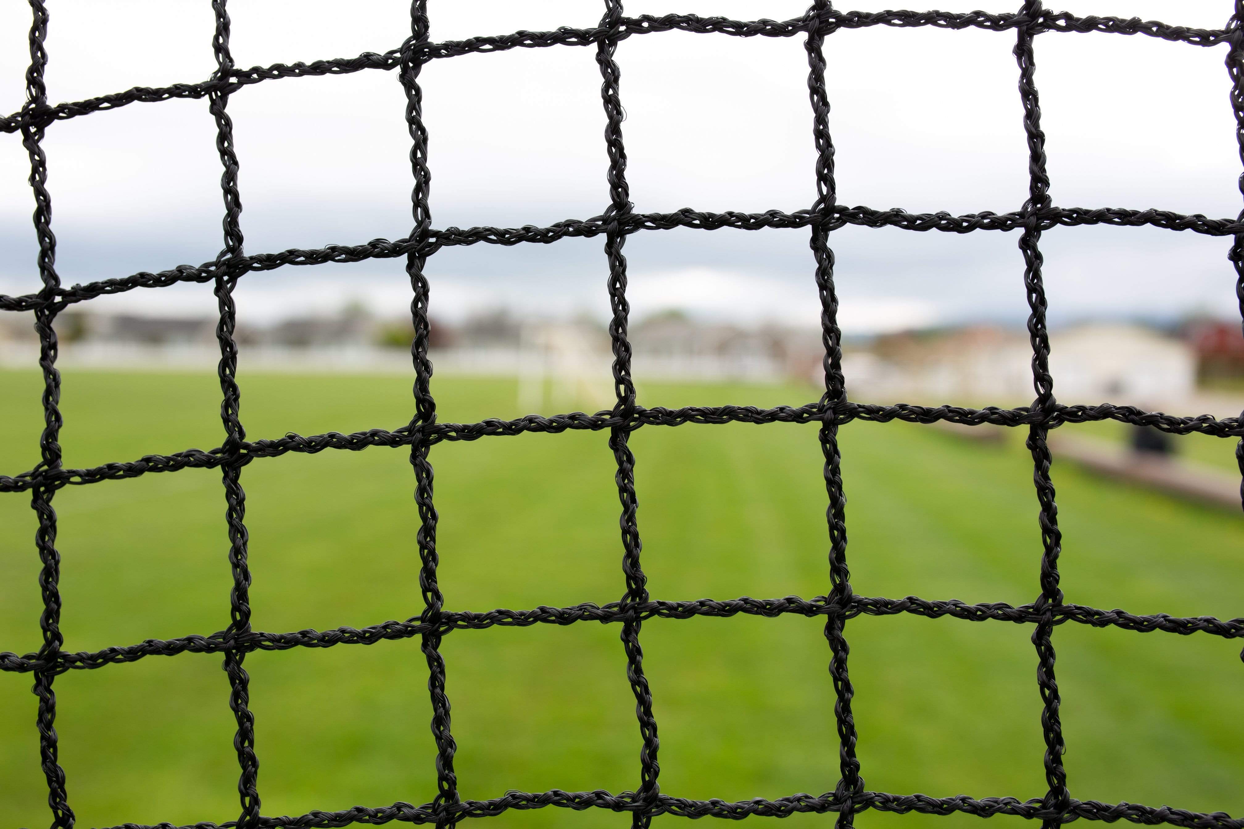 Freestanding Trapezoid Batting Cage netting close up with field grass