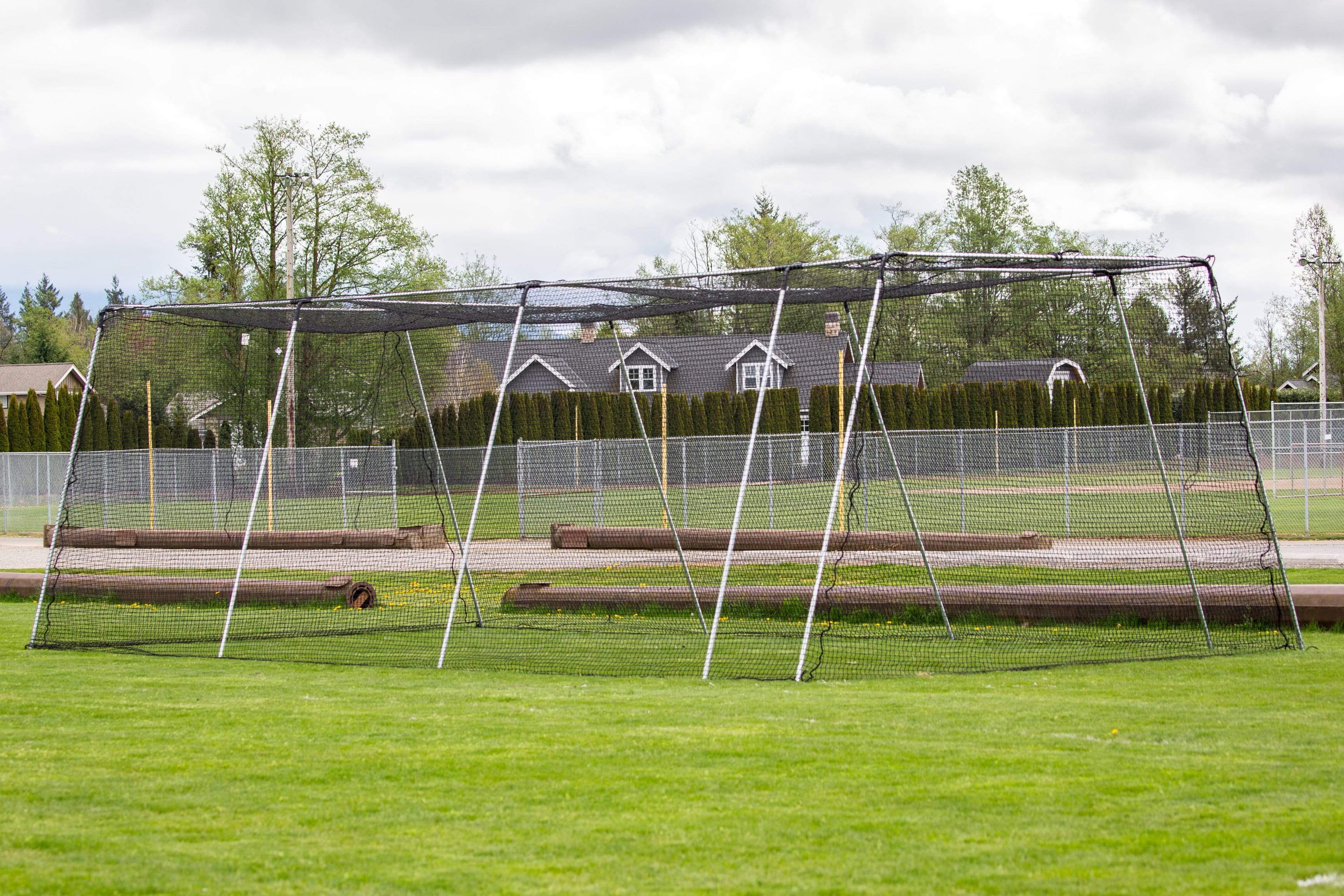 Freestanding Trapezoid Batting Cage on field grass