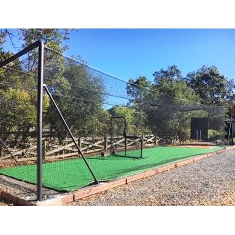 Iron Horse Ultra Batting Cage System in yard with blue skies and batting cage accessories