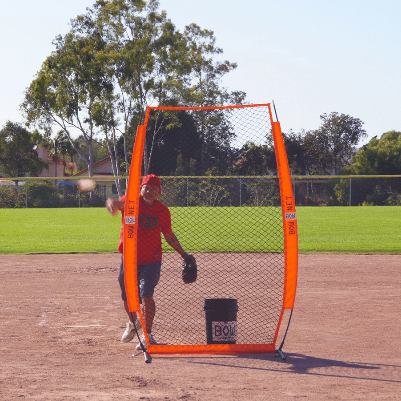 Man pitching to batter with the Protective I Screen in front of him