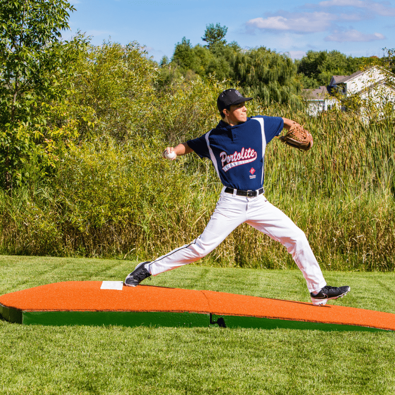 Man pitching off of the 2 Piece Indoor Practice Mound with Turf Clay